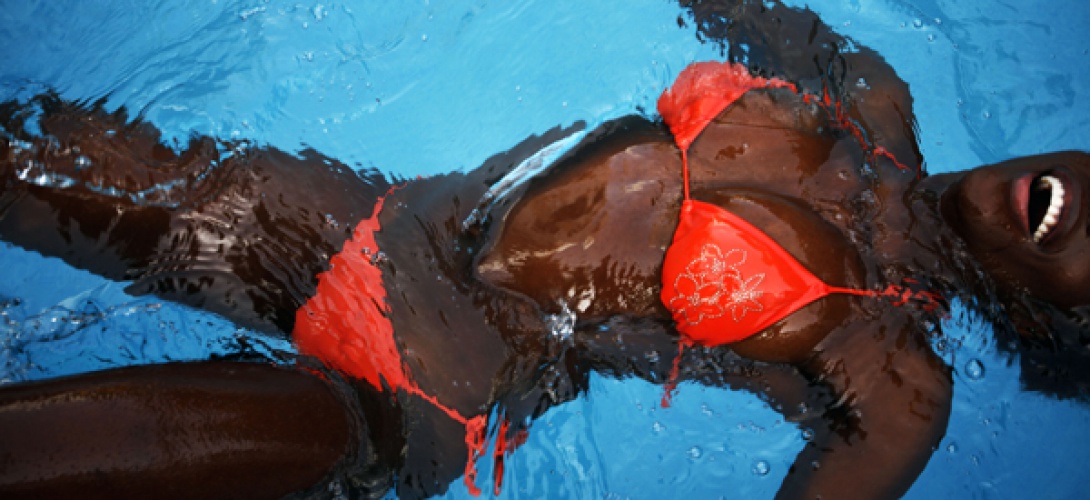 A Senegalese woman cools off in a swimming pool